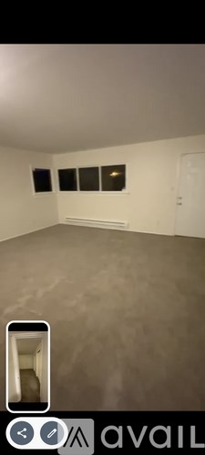 A room with a grey floor and white walls.