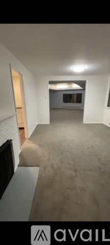 A room with a carpeted floor and a window.