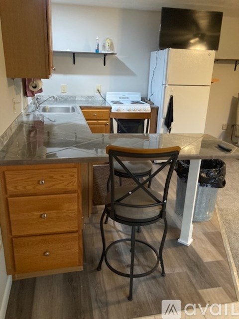 A kitchen with a table and chairs in the middle.
