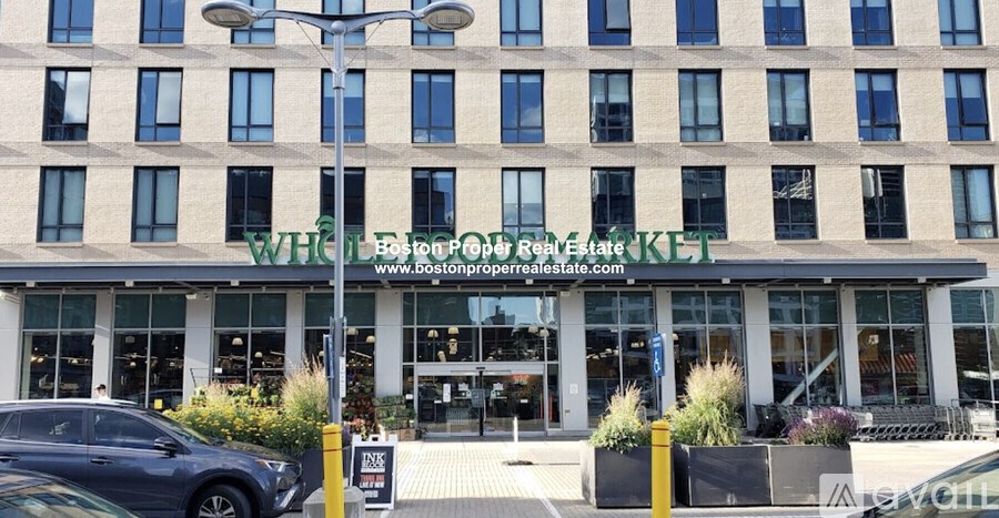 A building with a green awning and a sign that says "WHEN BOSTON PROPER REAL ESTATE" is shown.