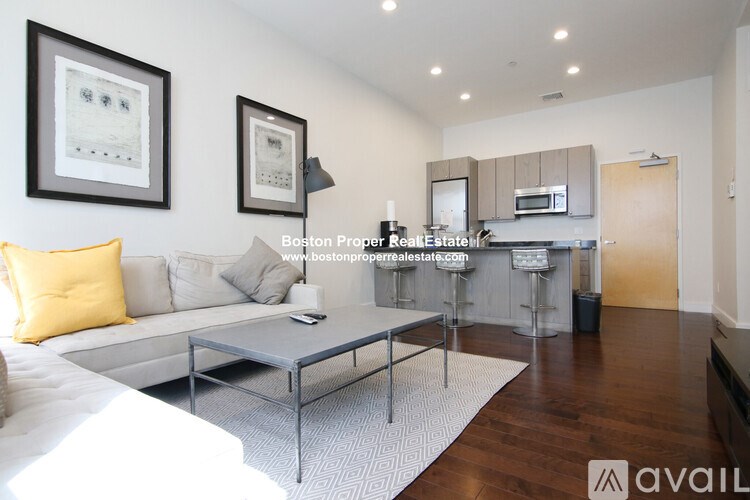 A modern living room with a white sofa and a coffee table.