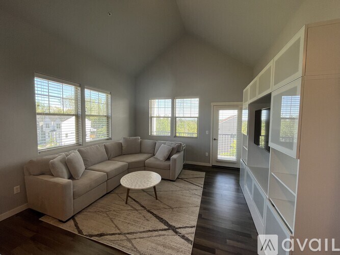 A living room with a large sectional sofa and a coffee table.