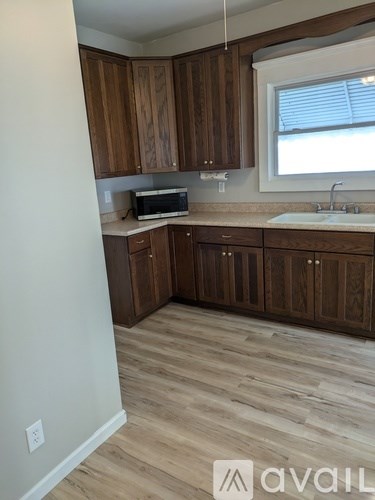 A kitchen with wooden cabinets and a white countertop.