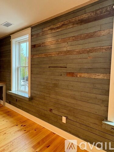 A room with wooden walls and a window.