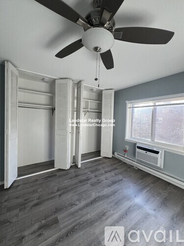 A room with a ceiling fan and a window.