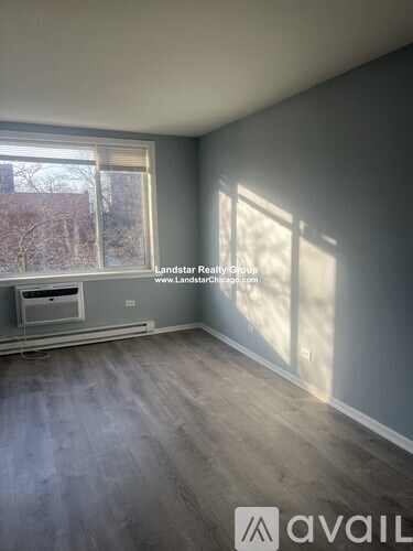 A room with a window and a wall-mounted air conditioner unit.