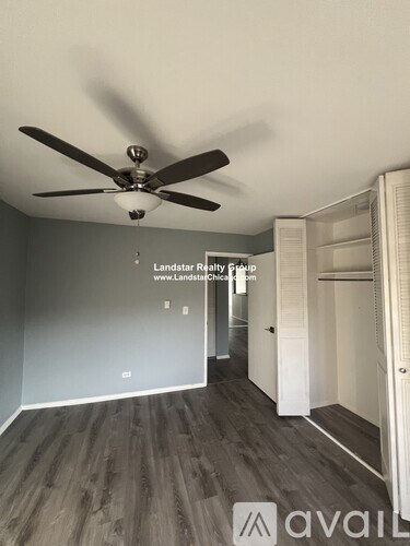 A room with a ceiling fan and a website address on the wall.