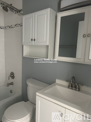 A white toilet sits next to a sink in a bathroom.