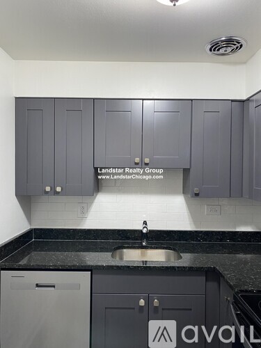 A kitchen with a sink and cabinets.