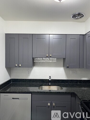 A kitchen with a sink and cabinets.