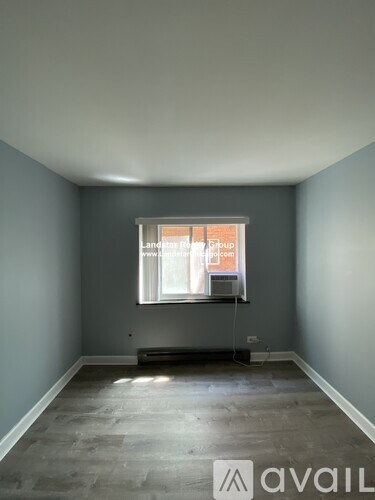 A room with a window and a sign that says "Lancelot Group".