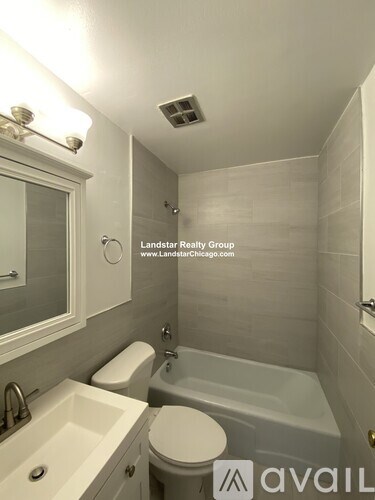 A bathroom with a toilet, sink, and bathtub.