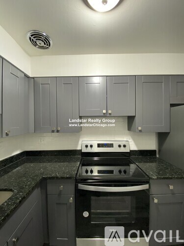 A kitchen with a stove top oven and cabinets.