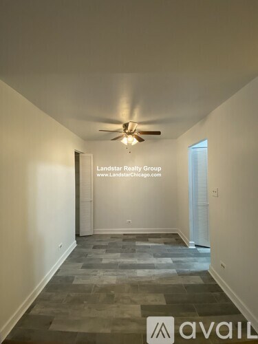 A room with a fan and a tiled floor.