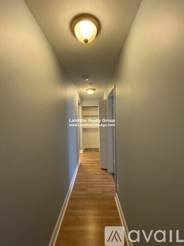 A long hallway with Landstar Realty Group written on the wall.