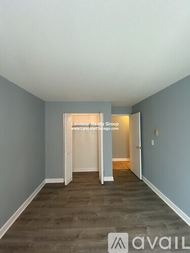 A room with a doorway leading to another room, with the text "Landstar Realty Group" and a website address on the wall.