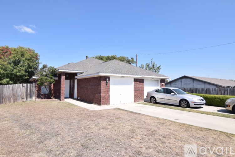 A house with a car parked in front of it.