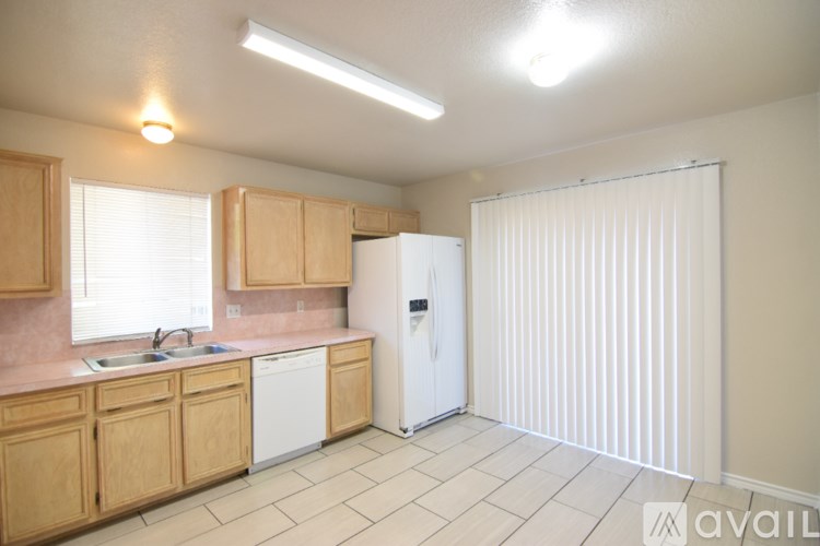 A kitchen with wooden cabinets and a white refrigerator.