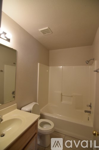 A bathroom with a toilet, sink, and bathtub.