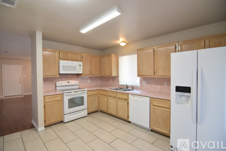A kitchen with wooden cabinets and white appliances.