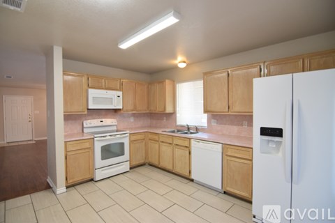 A kitchen with wooden cabinets and white appliances.