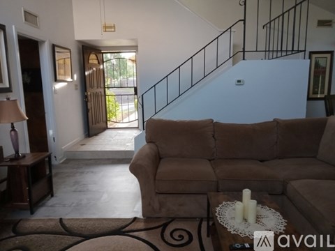 A living room with a brown couch and a coffee table.