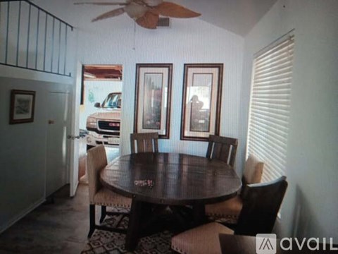 A dining room with a table and chairs.