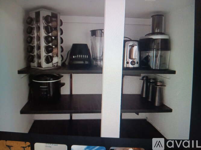 A kitchen counter with a blender, toaster, and a coffee maker.