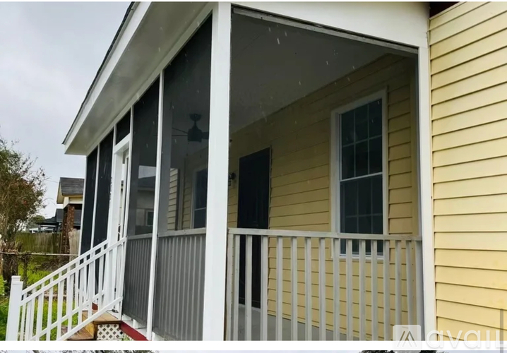 A house with a yellow exterior and a white porch.