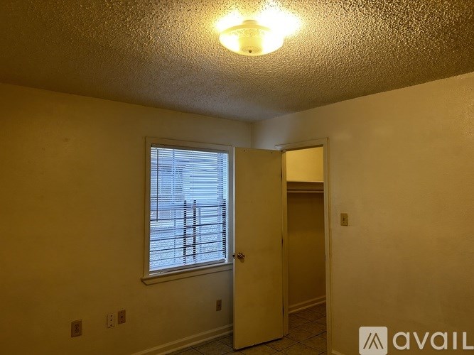 A room with a window and a door.