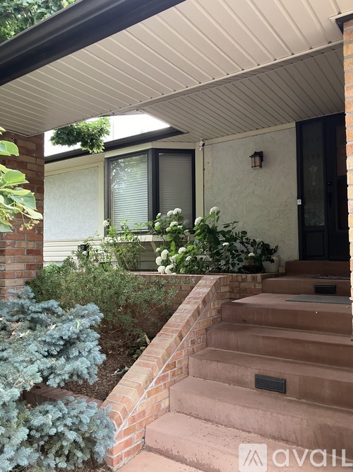 A house with a staircase leading to the front door.