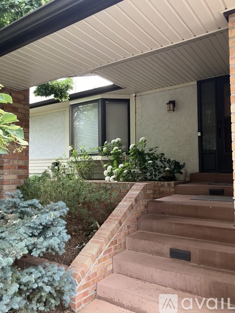A house with a staircase leading to the front door.