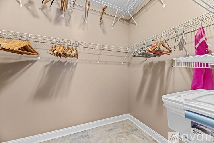 A room with a white closet and a white dresser.