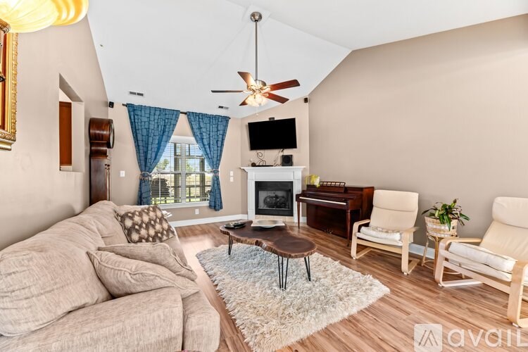 A living room with a beige couch, a coffee table, and a television.