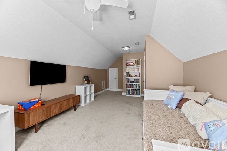 A bedroom with a bed, a TV, and a bookshelf.