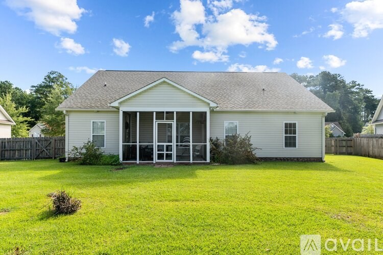 A house with a front yard and a fence.