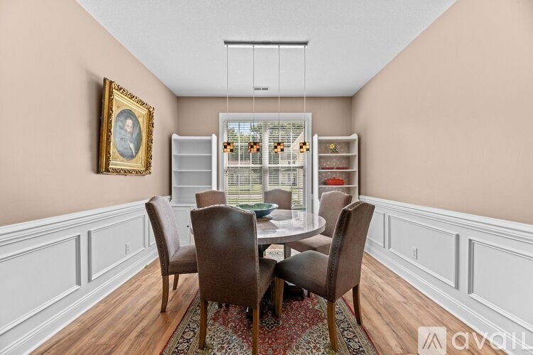 A dining room with a table set for four.