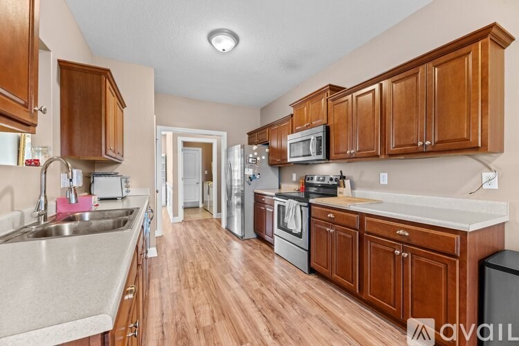 A kitchen with wooden cabinets and a white countertop.