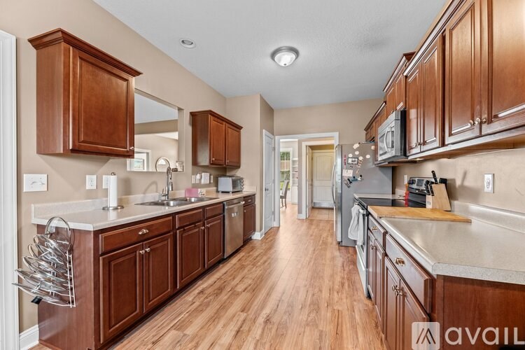 A kitchen with wooden cabinets and a white countertop.