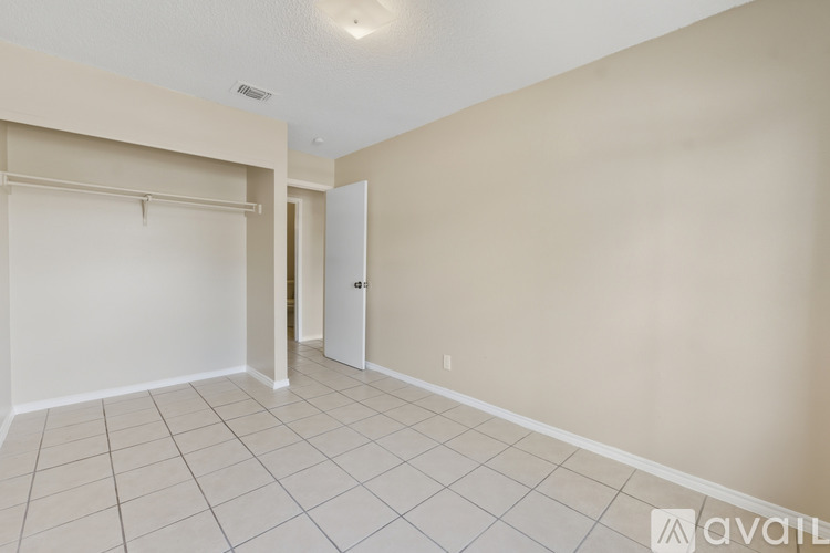 A room with a white door and a white wall.