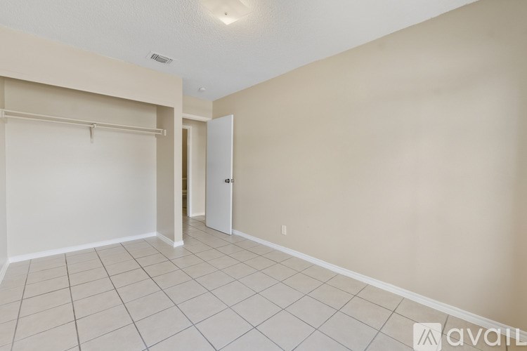 A room with a white door and a white wall.