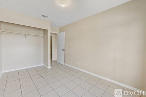 A room with a white door and a white wall.