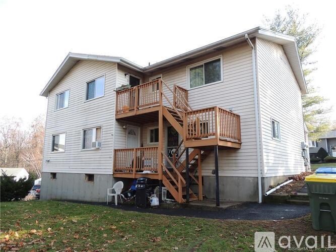 A two-story house with a deck and a garage.