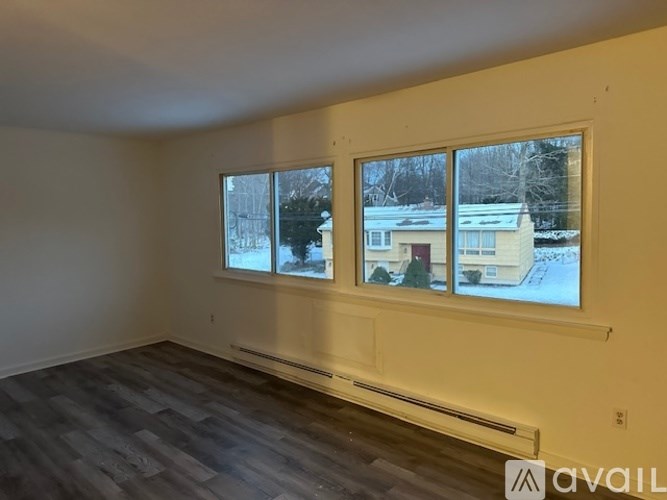 A room with a window showing a snowy scene outside.