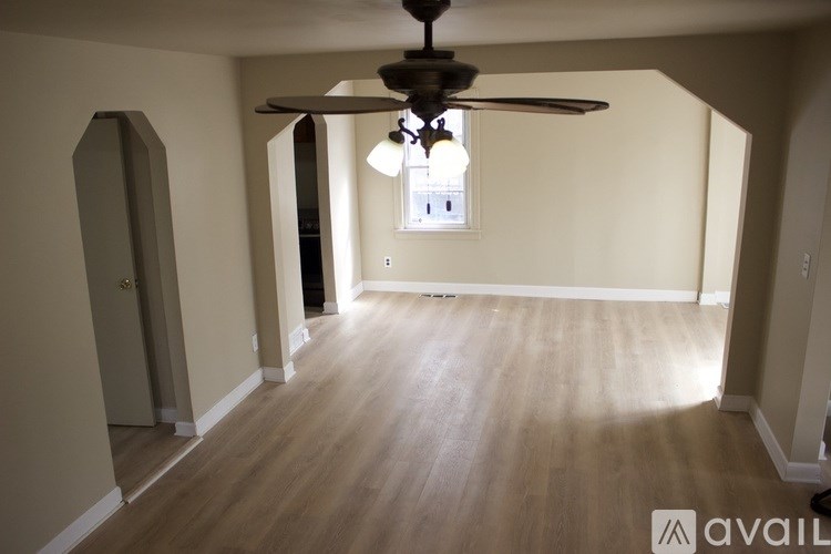 A room with a ceiling fan and a window.