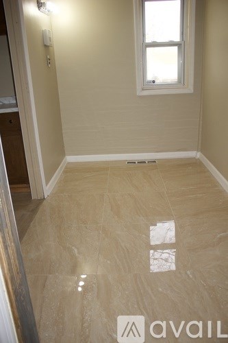 A room with a tile floor and a window.