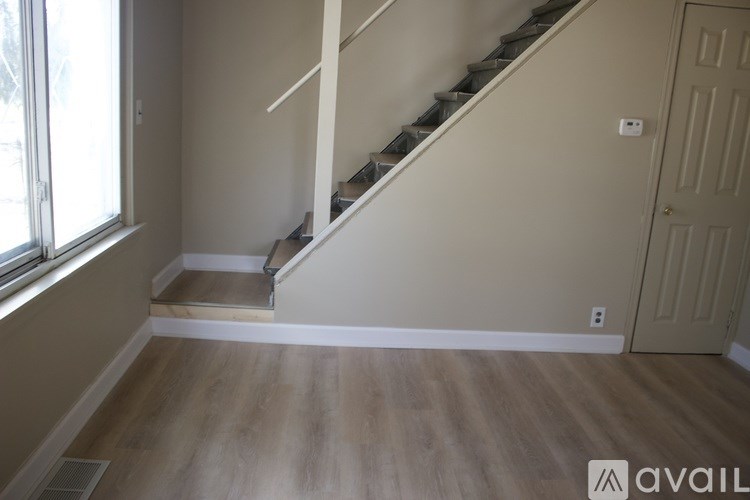 A room with a staircase leading to the upper floor.