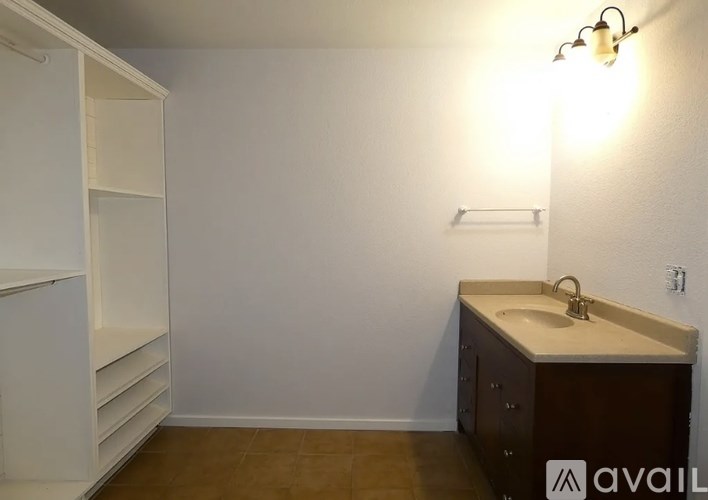 A bathroom with a sink and a cabinet.