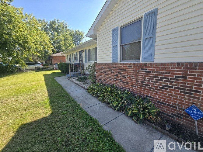A house with a blue sign that says "Available" on the front lawn.