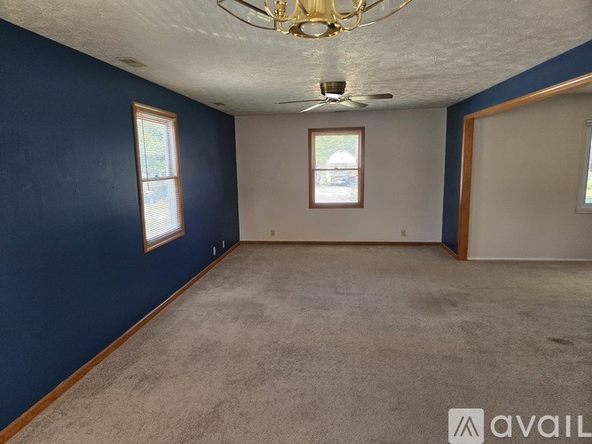 A room with blue walls and a carpeted floor.